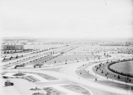 Albert Hall on left and Commonwealth Avenue from West Block showing young trees and roads, Canberra.