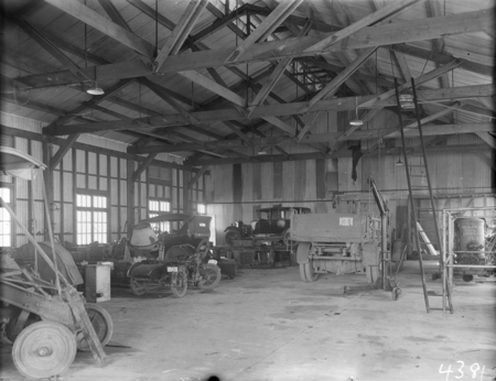 Interior of a garage showing cars, truck and a motor cycle at Kingston Depot.