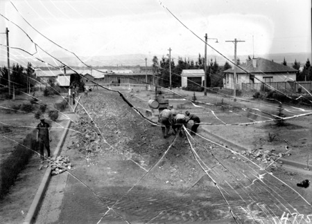 Giles Street Kingston showing tractor and workmen on road works,Negative cracked