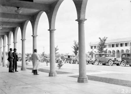 Cars lined up on Northbourne Avenue, from the Colonnades of the Sydney Building. Melbourne Building across the street.