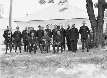 Group of policemen outside Acton Courthouse.