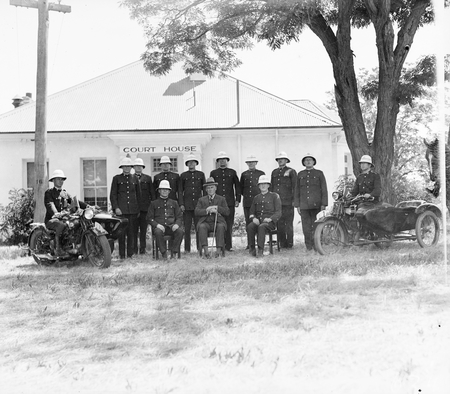 Group of policemen with helmets, outside Acton Courthouse. Troopers with motorcycle combinations and horses.