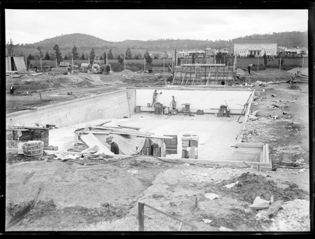 Manuka swimming pool under construction. Wall tiles being installed. Manuka Circle, Kingston.