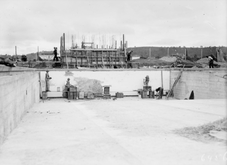 Manuka swimming pool under construction. Wall tiles being installed. Manuka Circle, Kingston.