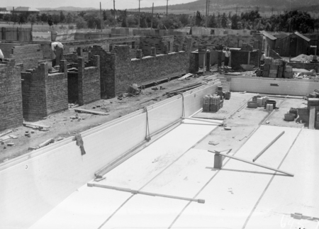 Manuka swimming pool under construction. Floor of the pool being placed. Manuka Circle, Kingston.