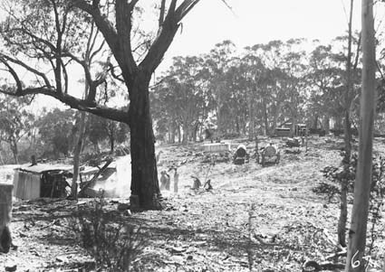 Steam shovel loading motor trucks