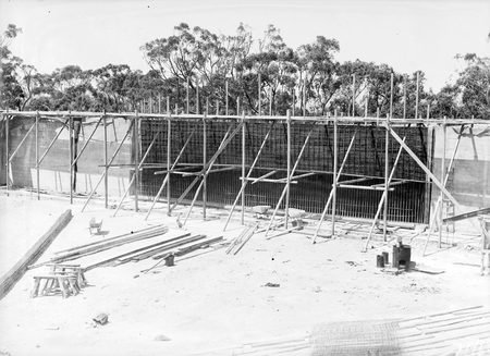 Black Mountain Reservoir, under construction. Form work and reinforcement for concreting being erected.