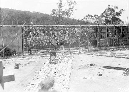 Black Mountain Reservoir, under construction. Form work and reinforcement for concreting being erected.