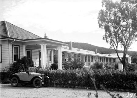 Buildings in the Canberra Community Hospital and baby Austin 7 tourer car.