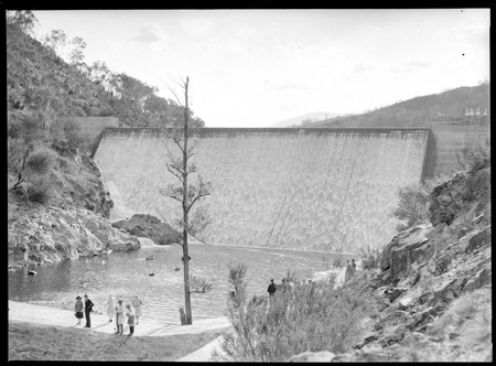 Cotter Dam spillway and stilling pond with visitors.