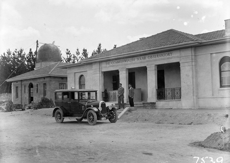 Administrative Building, Commonwealth Solar Observatory, Mt Stromlo, with Crossley motor car in foreground. Solar tower housing an 18 inch Coelostat.